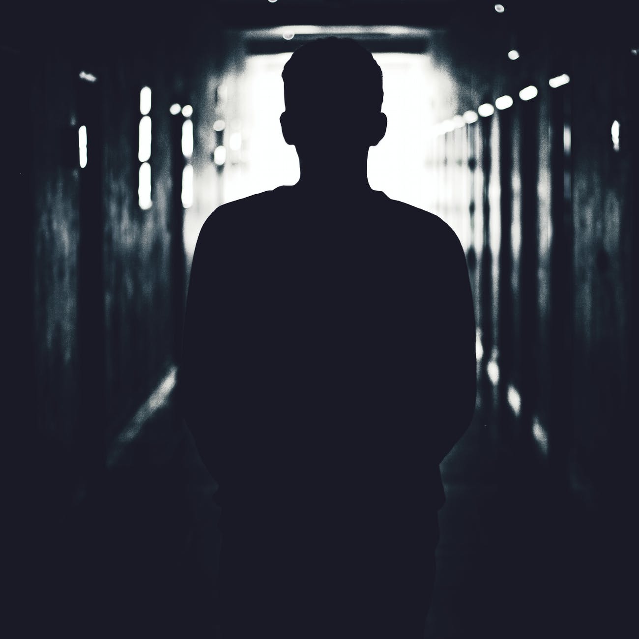 silhouette of man standing on hallway