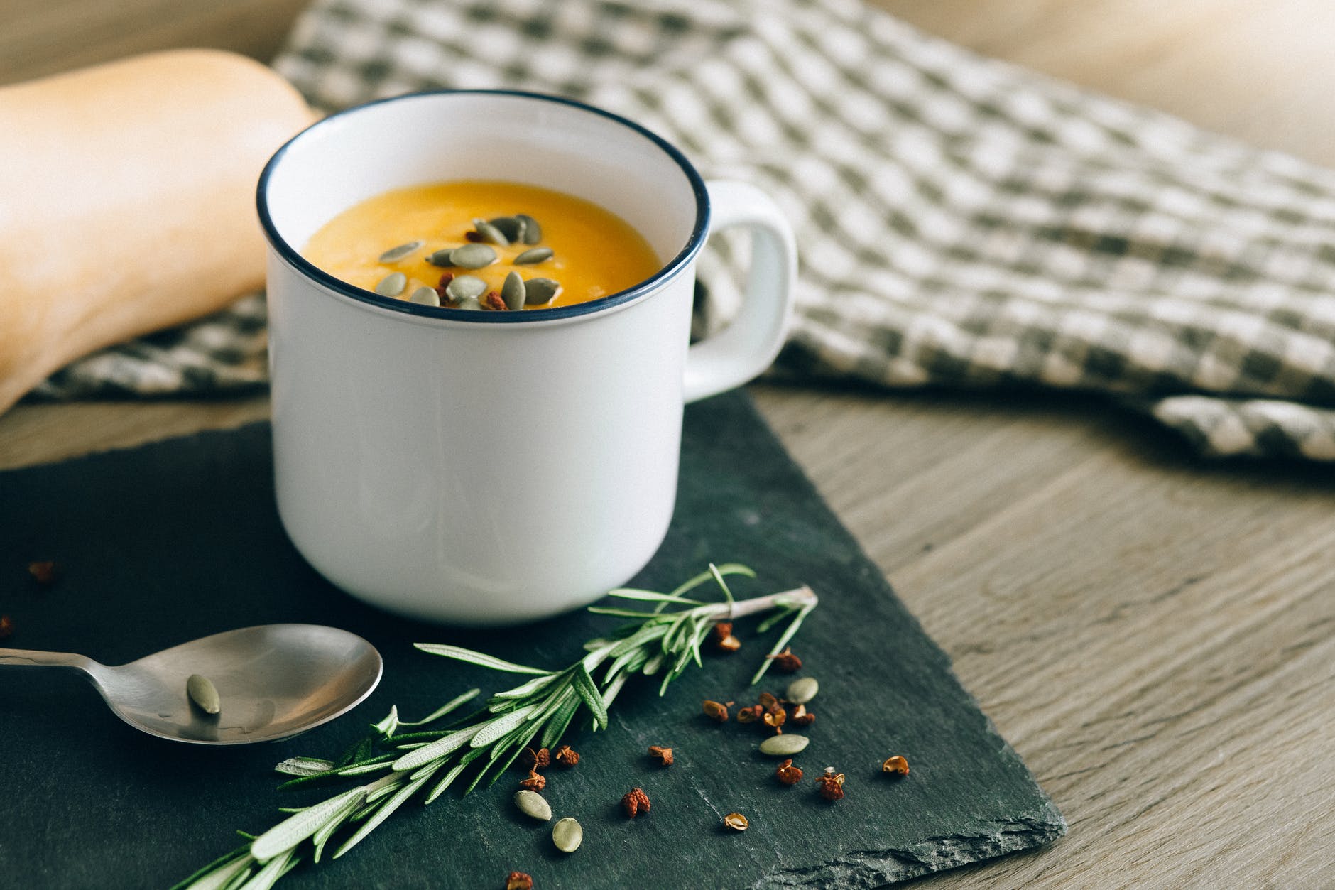 white ceramic mug with yellow liquid inside