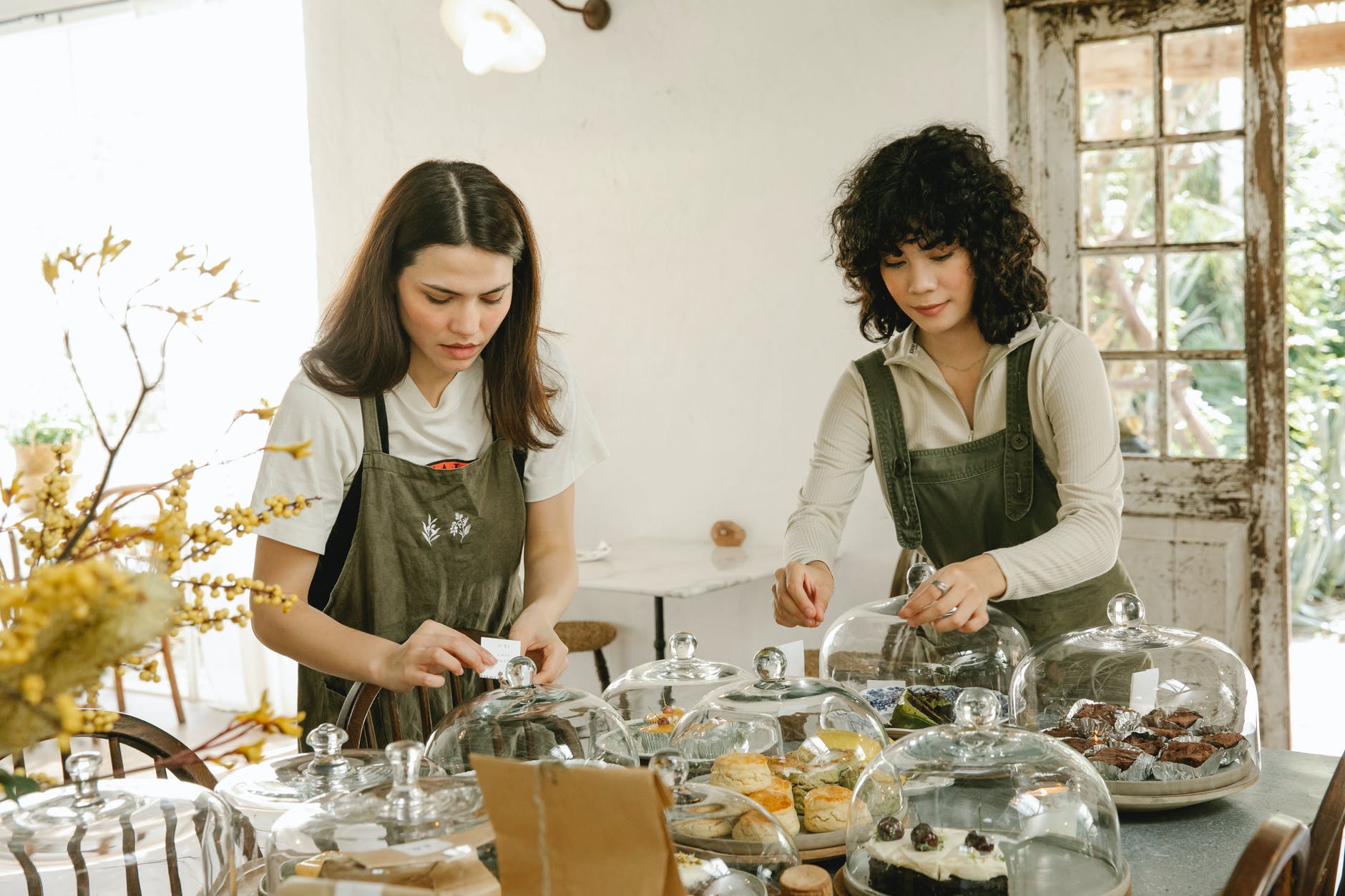 pensive waitress in apron serving table